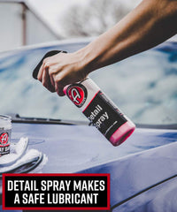 Demonstration of clay bar use on a vehicle's painted surface.