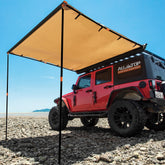 ALL-TOP Vehicle Awning extended beside SUV providing shaded shelter at a campsite.