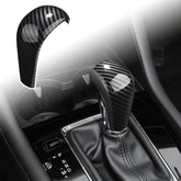 ANFOKAS gear shift knob cover in carbon fiber style enhances cockpit aesthetics and protects the knob.