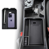 ANFOKAS armrest box for Kia Sportage NQ5 keeps coins and cards neatly organized.