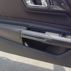 AOKIO Mustang carbon-style handle cover with adhesive back for easy installation.
