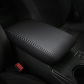 AOMSAZTO black armrest cover on Nissan Maxima center console protects surface.