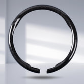 Aotoyou carbon fiber steering wheel cover clip-on in glossy black enhances grip and style.