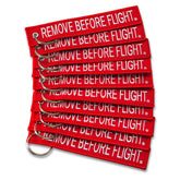Apex Imports AIXEPA remove-before-flight keychain in red and white for travel reminders.