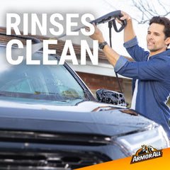 Suds cover a vehicle panel during a thorough wash.