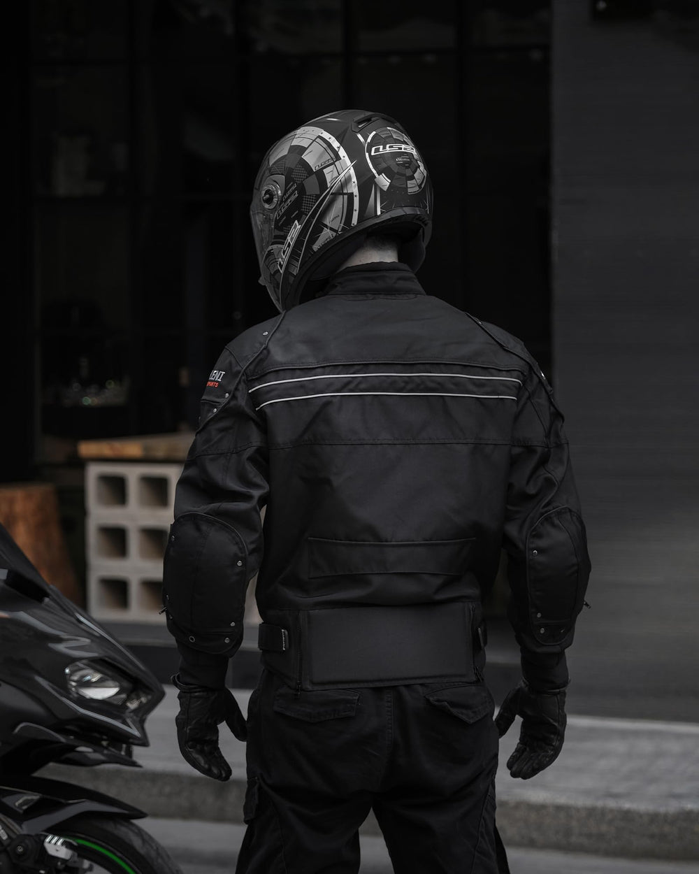 BORLENI motorcycle jacket side pocket view highlighting secure zipper storage.