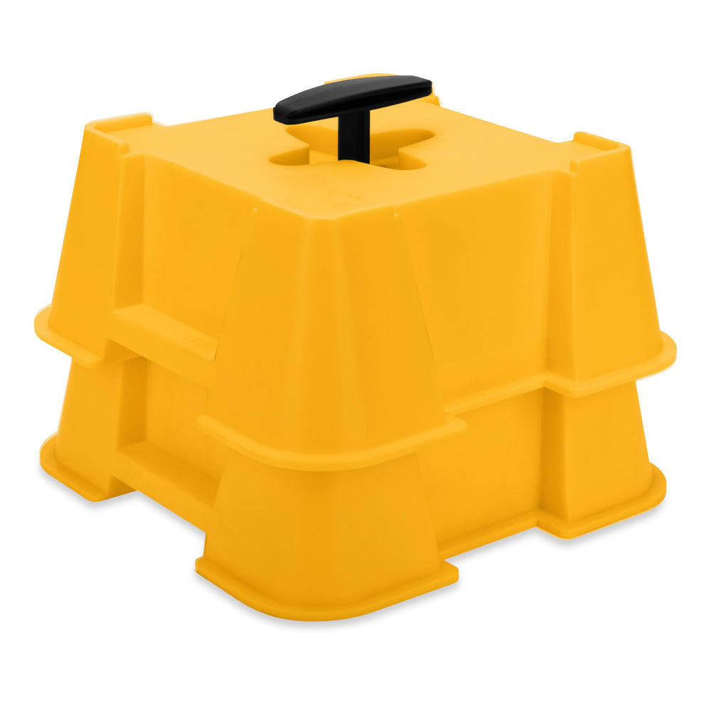 Camco FasTen RV Big Block base under a jack foot for stable leveling on uneven ground.