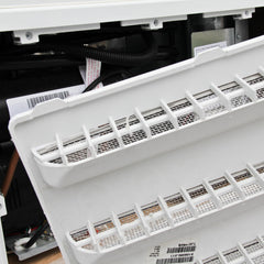Close-up of screen mesh filtering insects around vent opening.