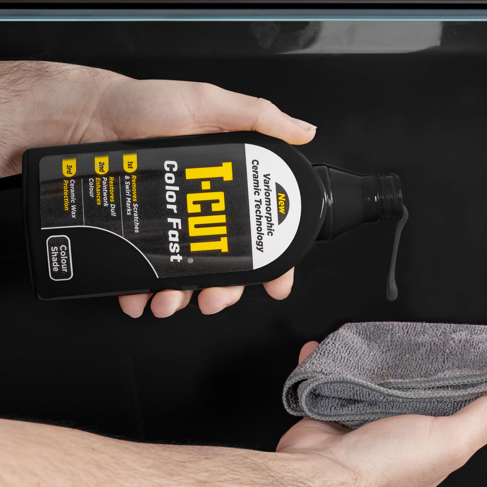Applying Car Gods T-Cut Color Fast Black with a foam pad for smooth, even coverage.