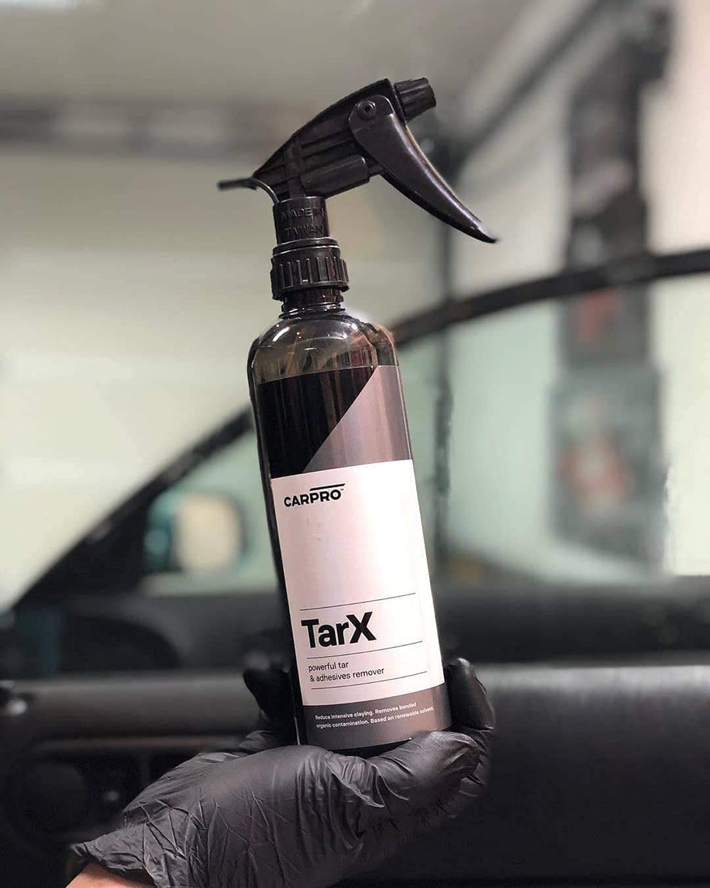 Applying TarX with the spray to remove tar and insects from paint