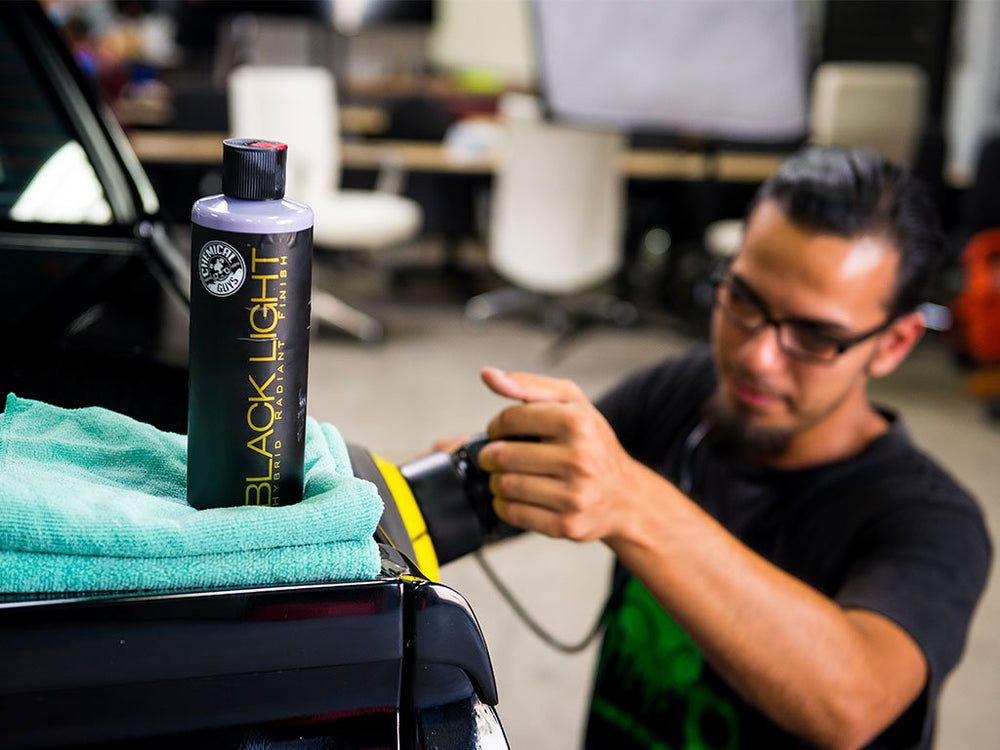 Before-and-after swirls reduced with Chemical Guys Black Light on dark finish