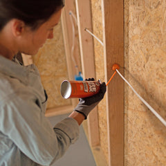 DAP FireBreak application in gaps shows sealing drafts and reducing air infiltration