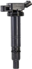 Denso 673-1308 ignition coil in engine bay, designed for efficient high-energy ignition