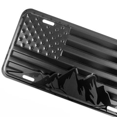 DillenCo embossed aluminum license plate with American flag and mountains for durable outdoor use.