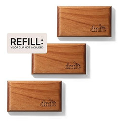 Close-up of Drift teak scent notes with amber and cedar accents.
