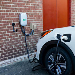 EXCELFU EV charging receptacle in use with cable connected outdoors.