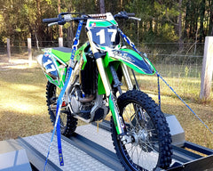 Fork-King dirt-bike fork protector is in use, shielding forks during loading.