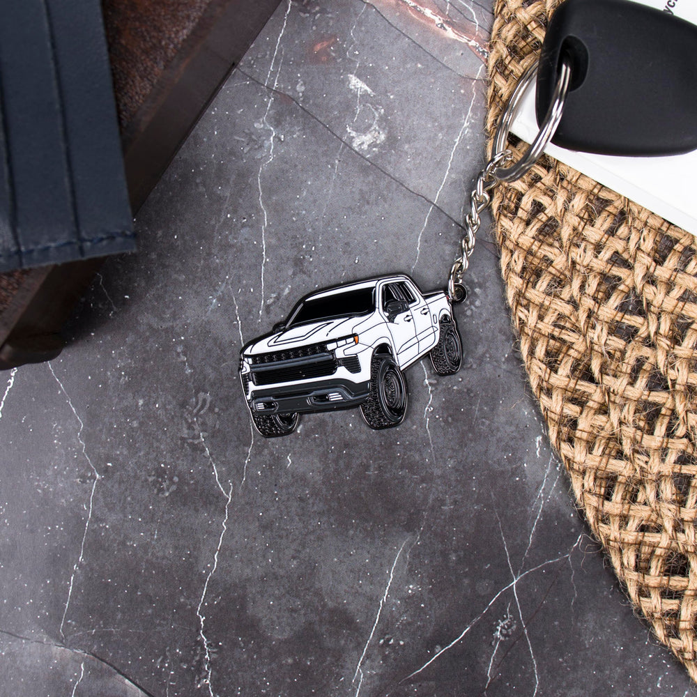 Four Wheel Beast white closeup enamel detail, raised design and premium feel.