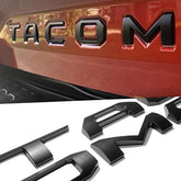 Generic Tacoma tailgate letters in 3D ABS emblems with matte black finish for 2016-2023.