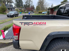 GO-GO.GROUP bedside decal set on clear vinyl with matte black and red 4x4 graphics.
