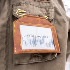 Harsh Gear license holder worn on vest during outdoor activities.