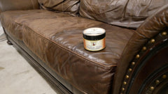 Howard Leather Salve on couch showing non greasy finish for furniture care