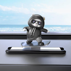 Kwak's skateboarding bear on dashboard glides smoothly for playful drives.