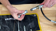 LockNLube rip-stop case with strap demonstrates secure portability for on-the-go use.