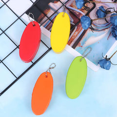 LOCOLO floating keychain in white remains visible against docks and surf.
