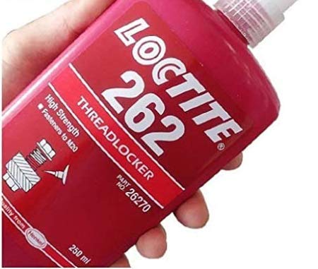Loctite 262 red threadlocker bottle secures metal joints for reliable assembly.
