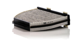 MANN-FILTER CUK 29 005 carbon layer closeup shows adsorption of pollutants and odors.