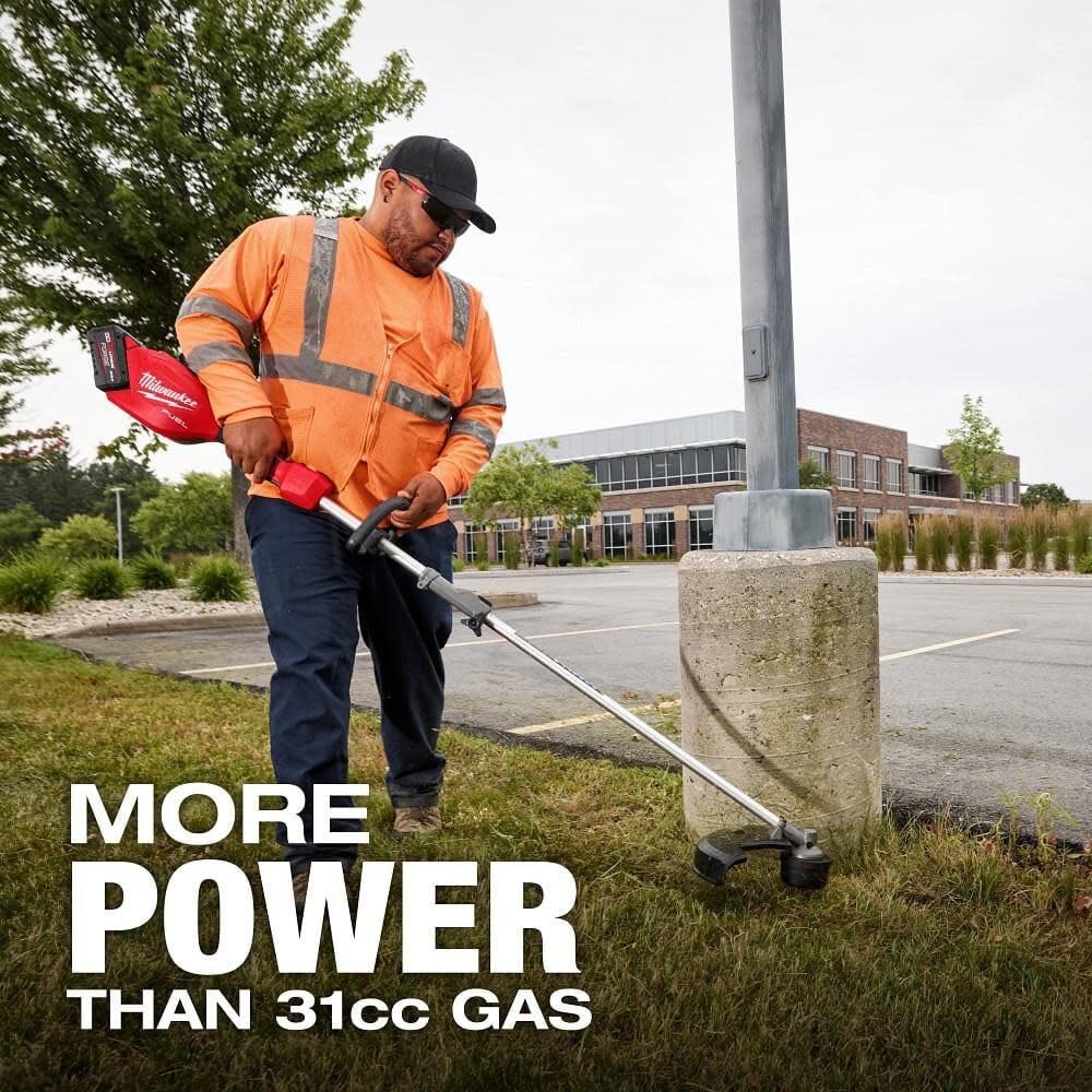 Outdoor scene of the trimmer in action along sidewalks.