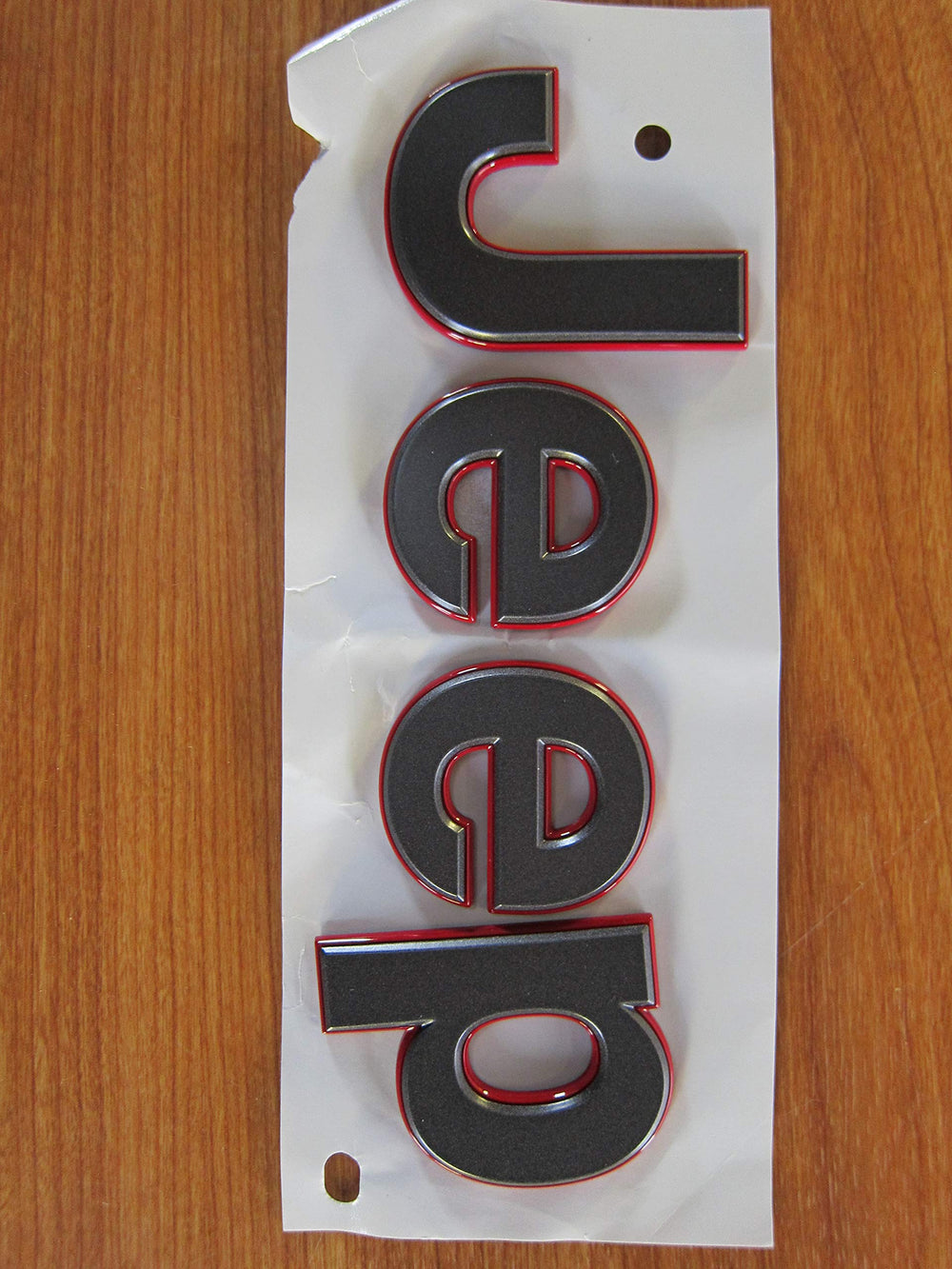 Mopar Jeep Wrangler JL gray badge front view showing authentic OEM styling