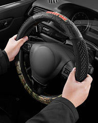 Mossy Oak camo steering wheel cover with forest pattern enhances rugged interior style.