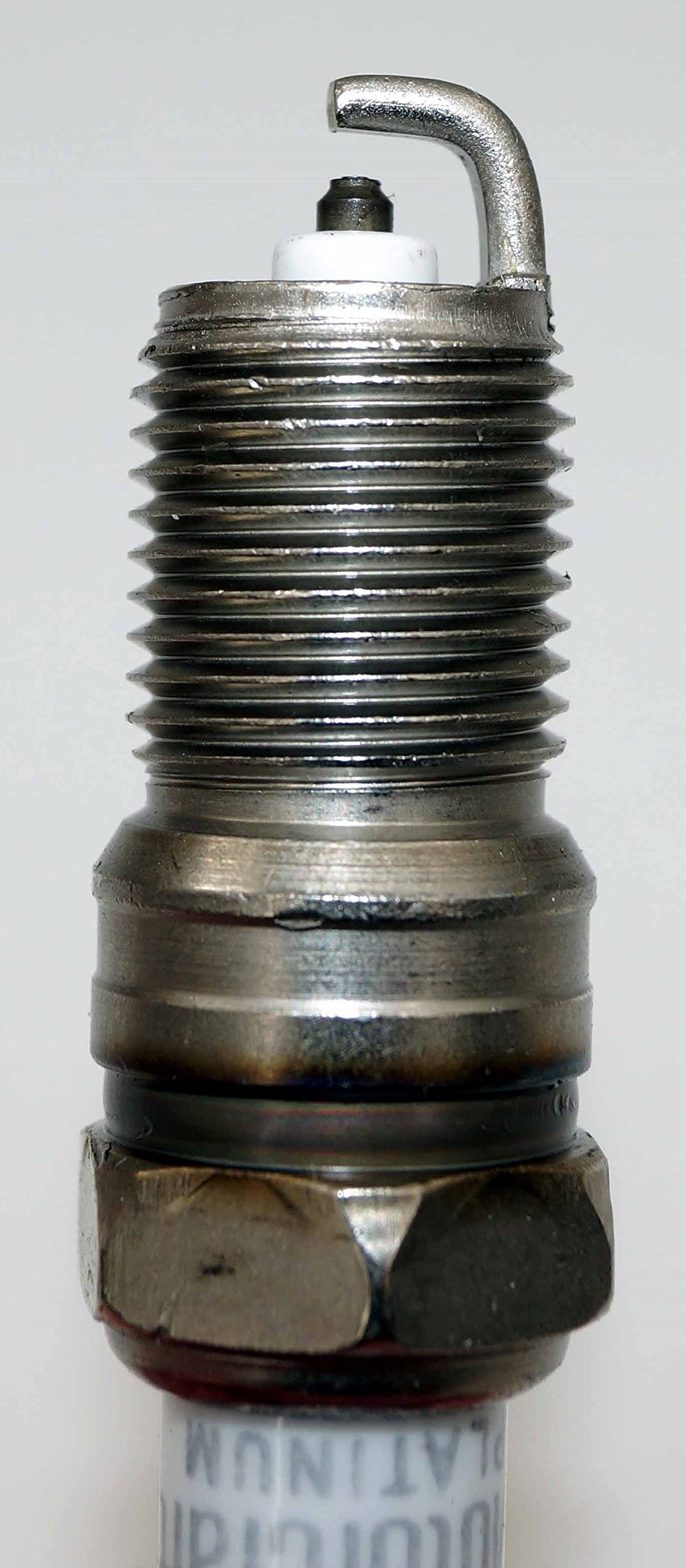 Motorcraft SP-479 close-up threads show precise fit for quick replacement