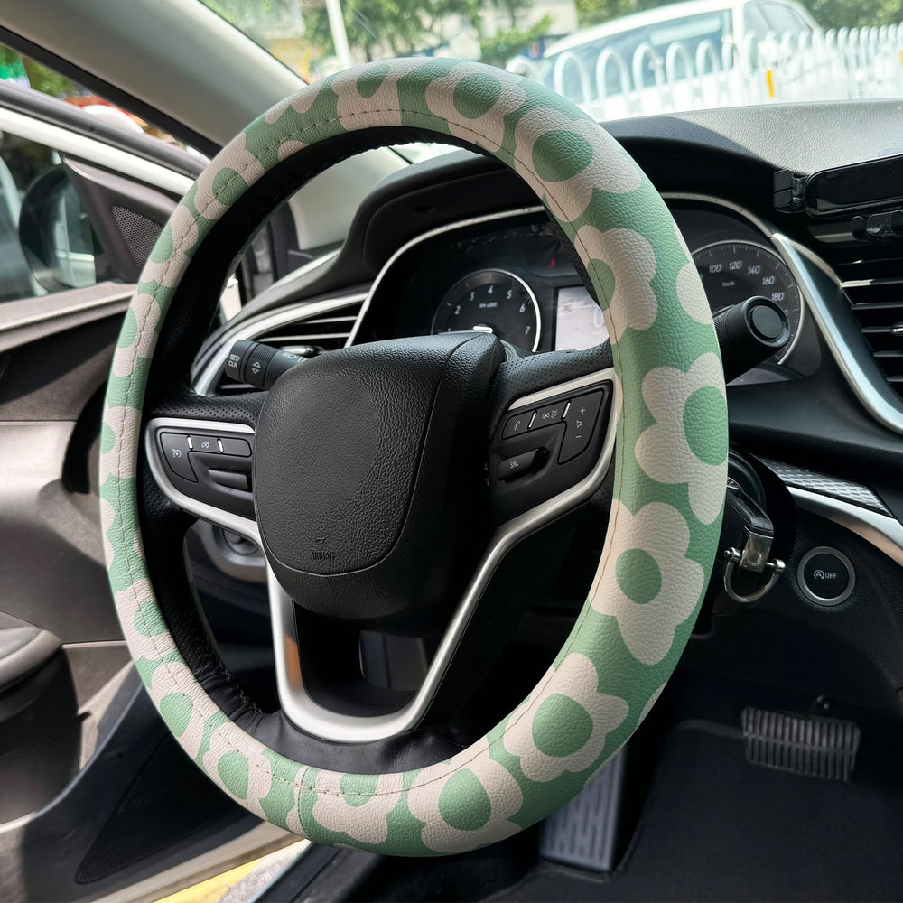Naxizo Vintage Groovy Flowers steering wheel cover on wheel for enhanced grip and style on 15-inch rims.