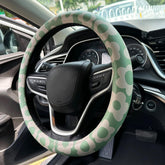 Naxizo Vintage Groovy Flowers steering wheel cover on wheel for enhanced grip and style on 15-inch rims.