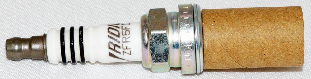 NGK 2477 iridium spark plug electrode edge closeup for reliable ignition.