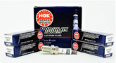 NGK Iridium IX spark plug close-up showing precise 0.6 mm electrode for faster starts