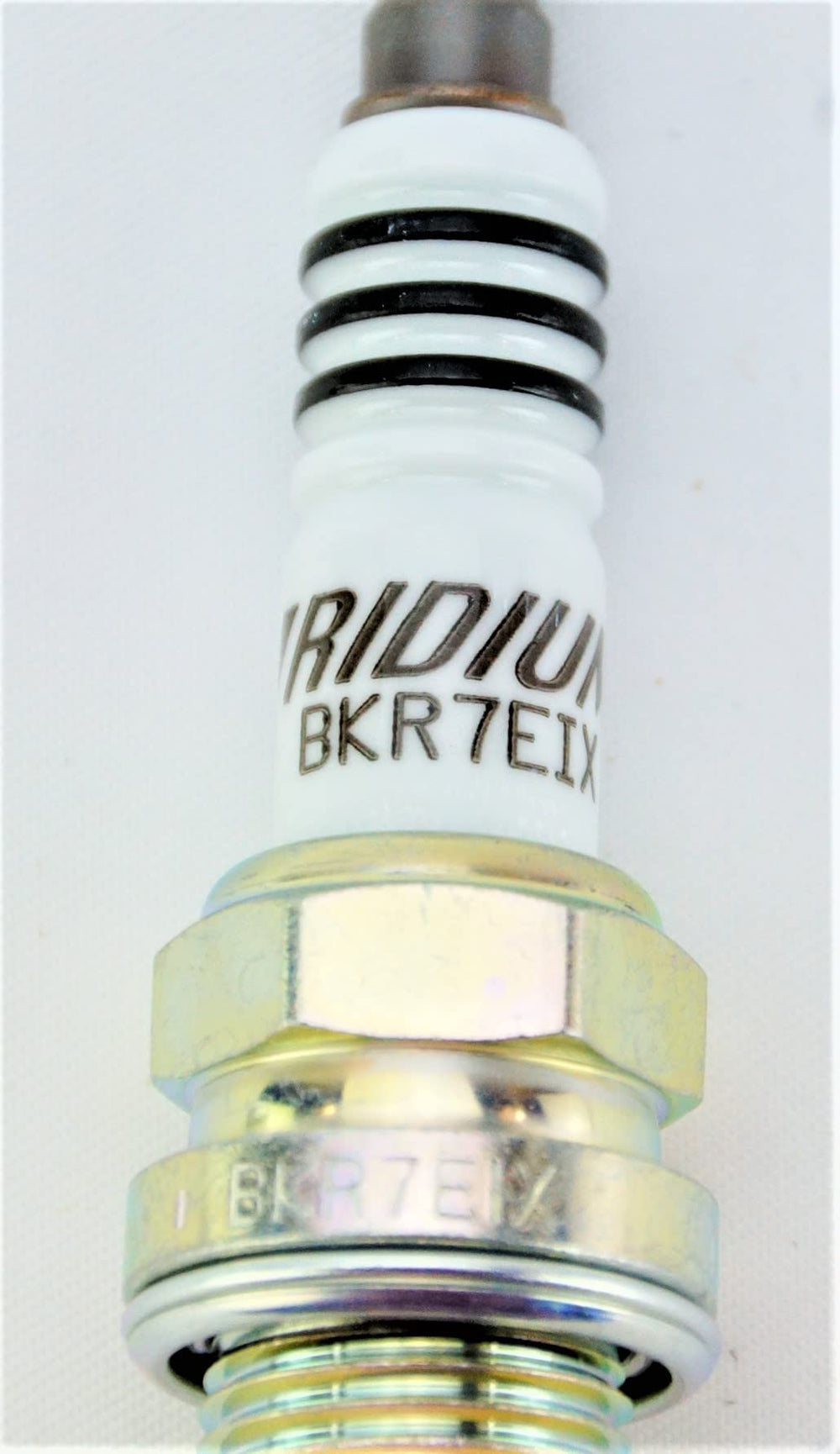 NGK Iridium IX spark plug ground electrode detail highlighting taper cut design