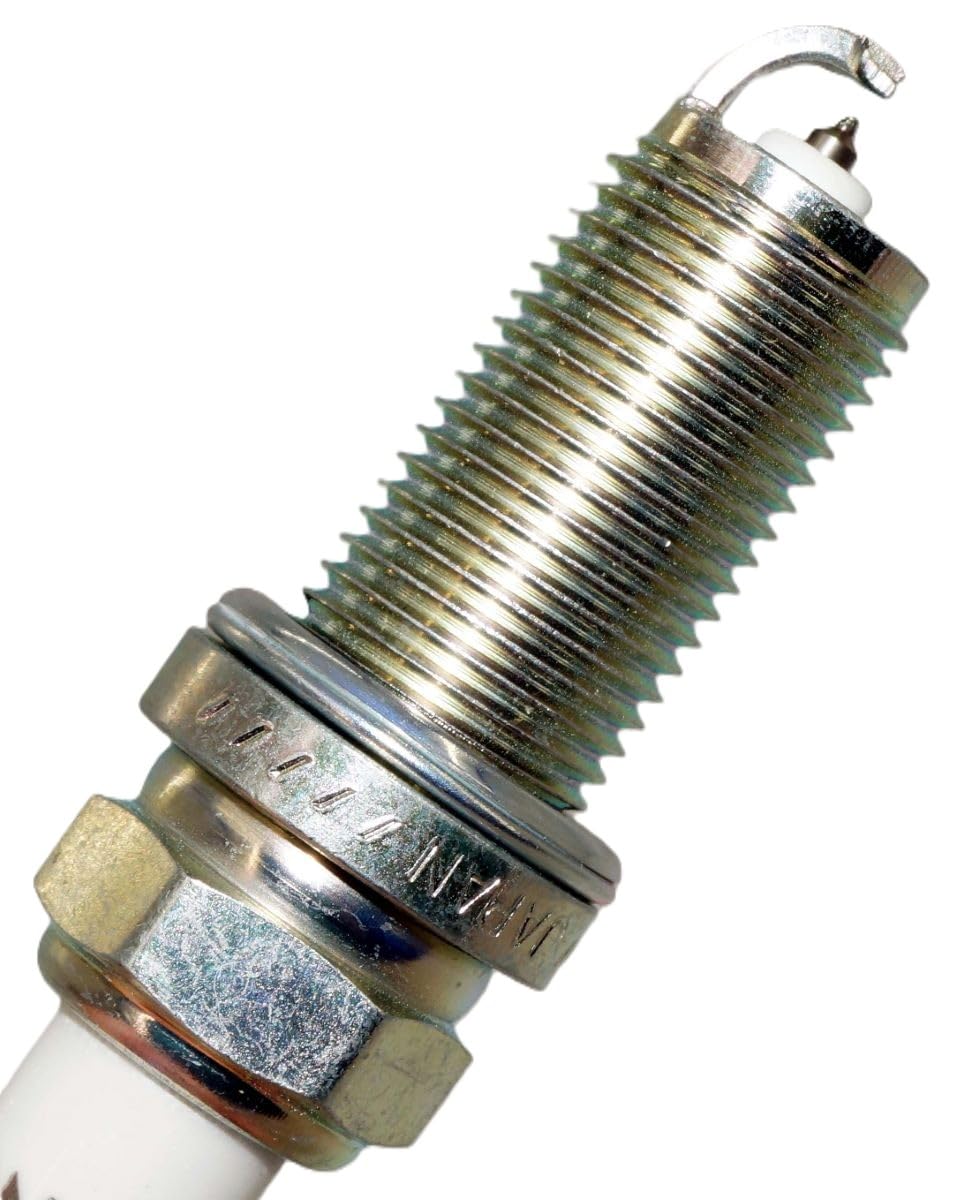 NGK 4469 Iridium IX spark plug in an engine bay showing corrosion-resistant plating.