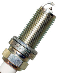 NGK 4469 Iridium IX spark plug in an engine bay showing corrosion-resistant plating.