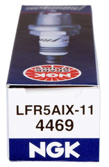 NGK 4469 Iridium IX spark plug next to a performance intake manifold.