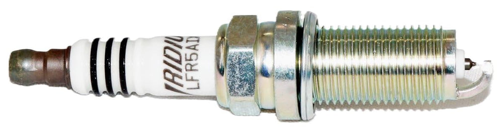 NGK 4469 Iridium IX spark plug installed in a V8 engine bay demonstrating strong ignition under load.