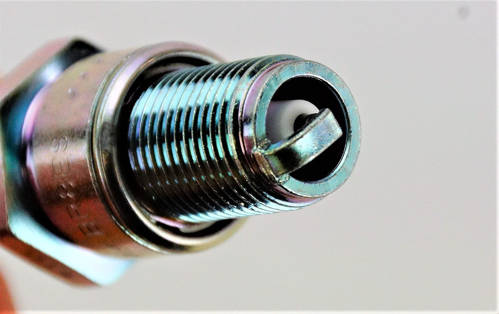 NGK BR8ES spark plug closeup tip reveals durable design for lasting performance.