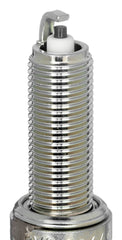 NGK LMAR7A-9 spark plug closeup shows corrugated insulator ribs for flashover prevention.