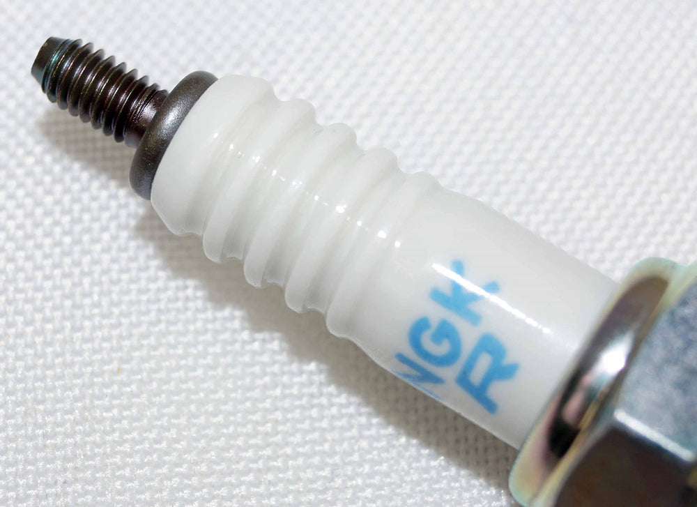 NGK spark plug electrode close-up shows precision design.