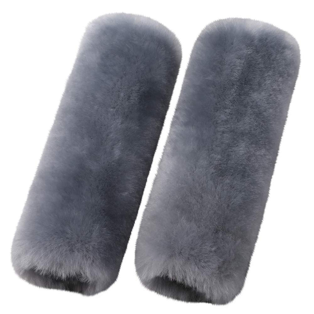 OGLAND merino wool seatbelt pad in blue gray resting on car seat with soft texture.