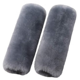 OGLAND merino wool seatbelt pad in blue gray resting on car seat with soft texture.
