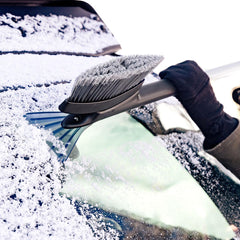 OXO Good Grips snowbrush in use on a frosty windshield with clear reach.